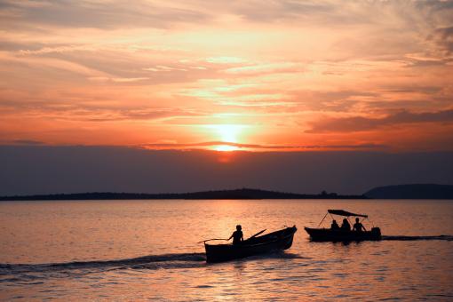 Silhouette of Small Boats on Water - Free Stock Photo