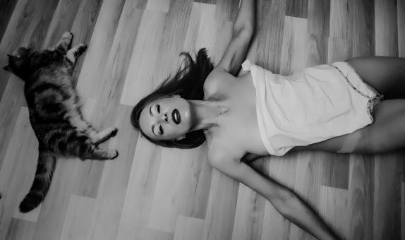 Free Stock Photo of Model on Floor and Pussycat - Black and White