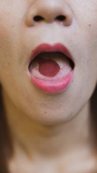 A Woman With A Rose Petal Inside Her Mouth - Free Stock Photo