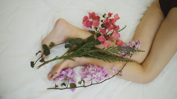 Free Stock Photo of Woman Wrapped With Flowers at Her Feet