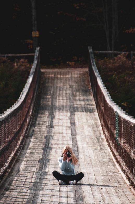 Free stock image of Girl with Camera Sitting on Bridge created by Quentin Lagadic