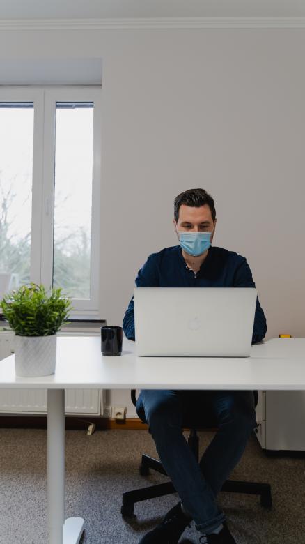 Free stock image of Man with Mask working on Laptop created by Maxime
