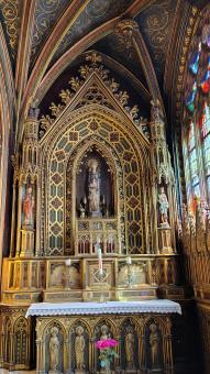 Gothic Church Altar with Blue Stained Glass Windows and Gold Details