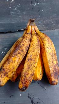 A banana with a close-up, against a black background, A banana f