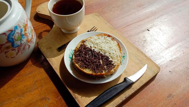A mini photo of a martabak with a chocolate topping and grated c