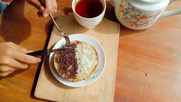 A mini photo of a martabak with a chocolate topping and grated c