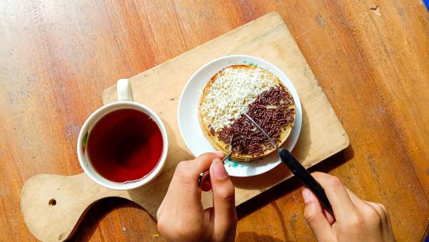 A mini photo of a martabak with a chocolate topping and grated c