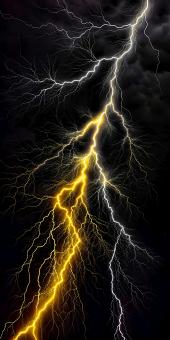 Dramatic Yellow and White Lightning Bolt Streaks Across a Dark Stormy 